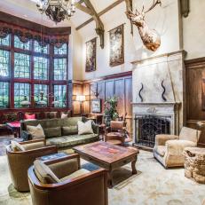 Windows, Vaulted Ceiling, Wood Paneling Create Drama in Large Den