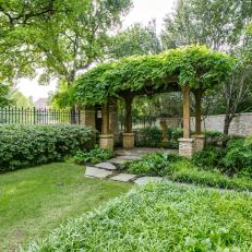 Pergola Creates Elegant Entrance to English Garden Backyard