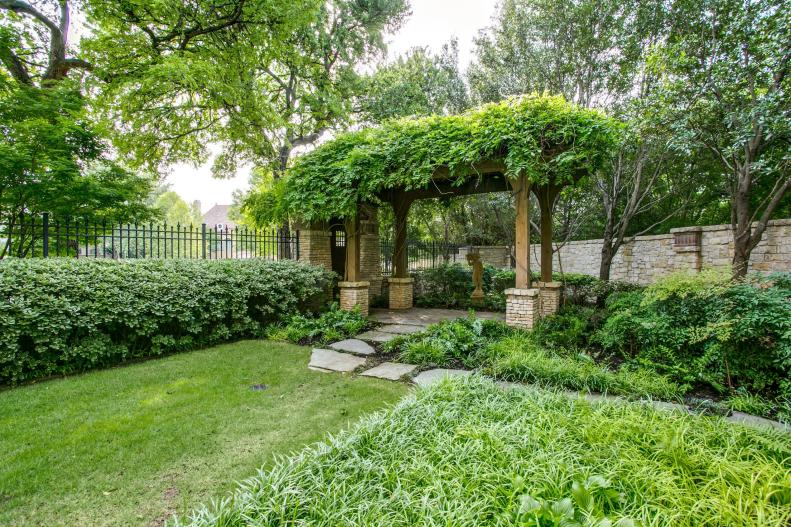 Backyard With Pergola Topped With Climbing Vines