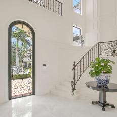 Mediterranean-Modern Foyer With Crisp White Walls, Marble Floors