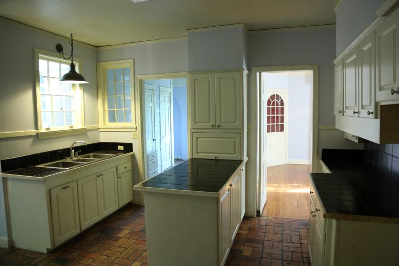 Counters and cabinets in the center of the room create a barrier that disrupts room flow in the Saxton kitchen before renovation on Home Town. (Before 13)