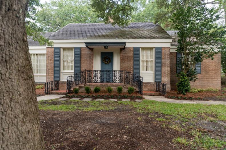 As seen on Home Town, Ben and Erin Napier have completely renovated the Saxton residence in Laurel, Mississippi.  New paint, window shutters and landscaping help to dress up the exterior. (After 2)