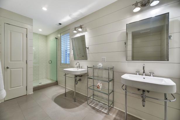modern master bathroom with pedestal sinks