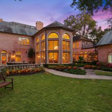 Majestic Dallas Mansion Casts Warm Glow Over Gardens