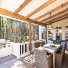 Covered Porch Features Grill, View of Surrounding Pine Trees