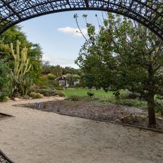Contemporary Garden With Huge Metal Arbor, Gravel Path