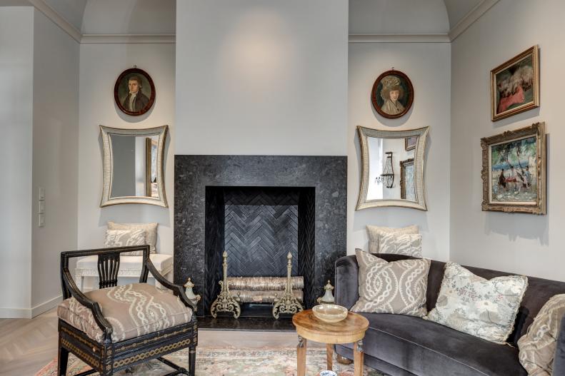 Comfortable Chairs Sit In Front Of A Large Fireplace
