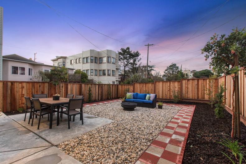 Wooden Privacy Fence Surrounds Outdoor Furniture and Fire-pit
