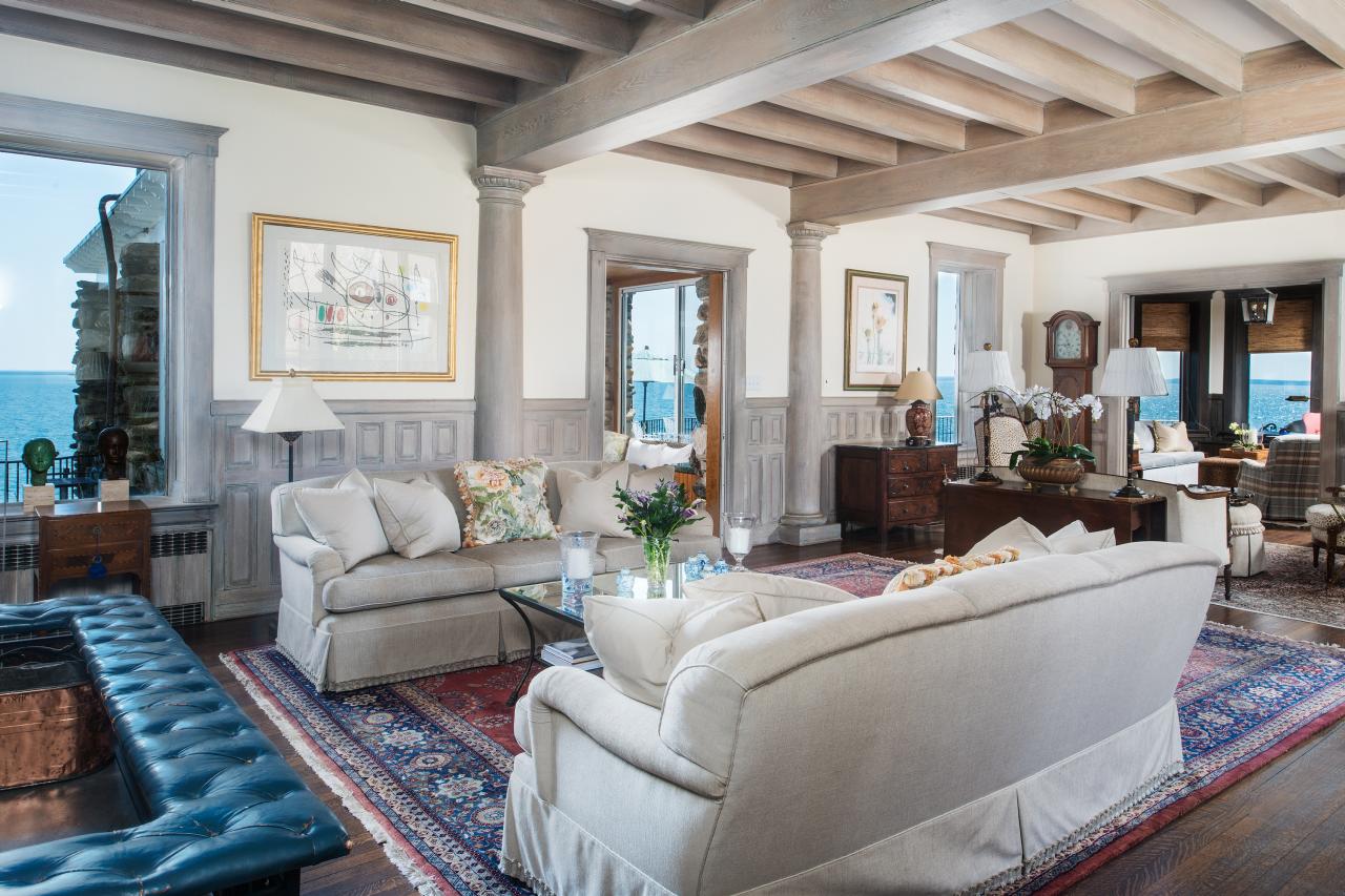 Separate Sitting Areas Defined By Rugs Break Up Large Living