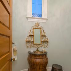Powder Room With Gold Decor Tucked Away in Turret