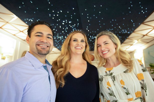 Portrait of Grace, Amy, and Isaac Flores with the star ceiling during reveal.