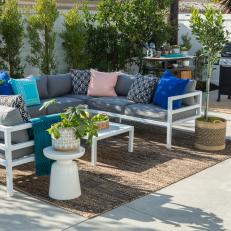 Contemporary White Patio with Gray Sofa and Blue Pillows 