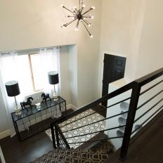Modern Black Staircase with Hardwood Brown Floors 
