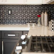 Modern Black Kitchen with Black and White Tile Backsplash 