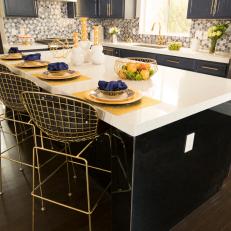 Black & White Modern Kitchen with Black & White Island and Gold Chairs 