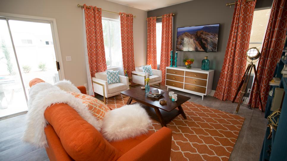 Modern Neutral Living Room with Orange Sofa and White Armchairs | HGTV