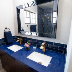 Modern Blue Bathroom with Blue Vanity and Tile Backsplash 