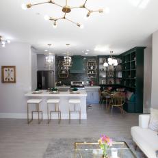 Contemporary Gray Living Room and Kitchen with Gold Light Fixtures 