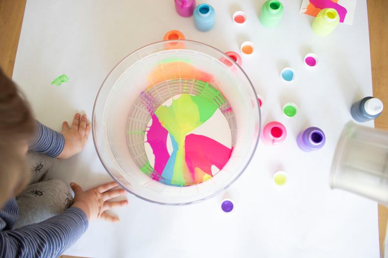 Using a salad spinner to create messy, colorful paint art with kids. 