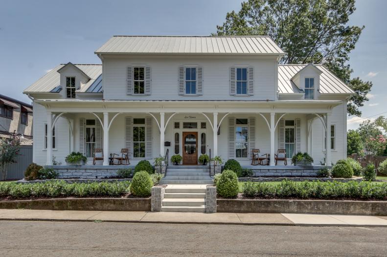 Home Exterior Featuring Large White Front Porch With Rocking Chairs