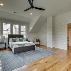 Bedroom With High Ceiling, Shiplap Walls and Gray Area Rug
