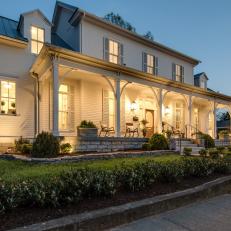 Warm Sconce Lights Illuminate This Expansive Front Porch