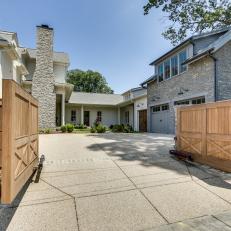 Textured Driveway With Wooden Gate Leading to Garage