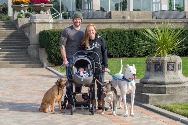 Mina Starsiak Hawk (R) and her husband Steve Hawk (L) pose with their baby, Jack, and their dogsBeatrice (L, brown), Sophie (C, grey) and Frank (R, white) at Garfield Park in Indianapolis as seen on HGTV's Good Bones.