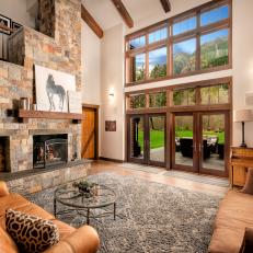 Living Room With Floor-to-Ceiling Windows and Stone Fireplace