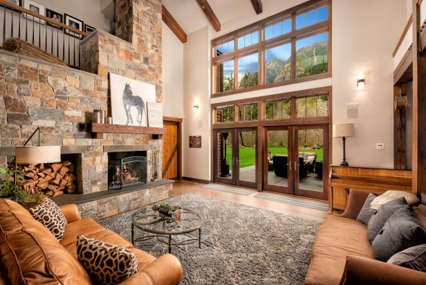 Living Room With Floor To Ceiling Windows And Stone Fireplace Hgtv