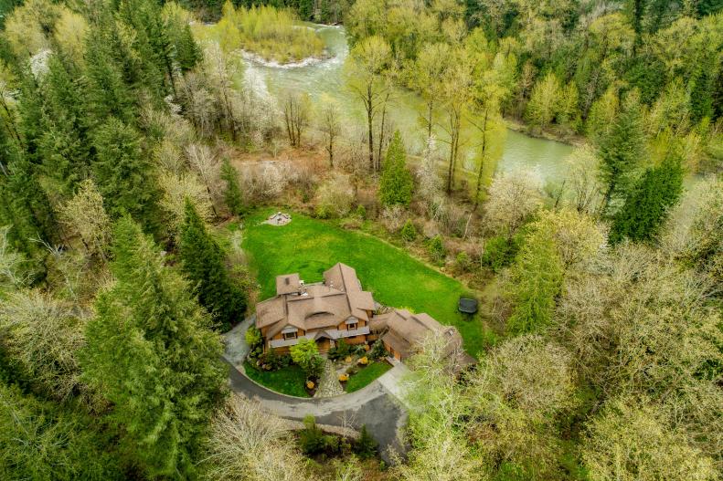 Riverfront Mansion Surrounded by Forest and Well-Tended Lawn