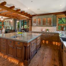 Kitchen With Large Island, Stone Countertops, and Indoor Arbor