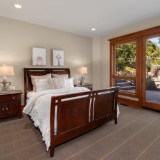 Bedroom With Sleigh Bed and Easy Access to the Patio