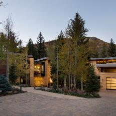Evening View of Contemporary Home and Garage With Interior Lights On