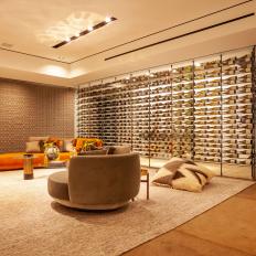Glass-Walled Wine Cellar Next to Neutral Contemporary Lounge