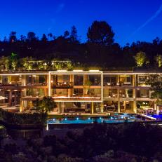 Nighttime View of 3-Story Contemporary Mansion With 30-Foot Fire Pit Lit Up