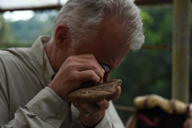 Host Scott Wolter inspects alien artifacts at the JAC Detector base camp in the jungle of Veracruz, Mexico. As seen on Travel Channel's America Unearthed.