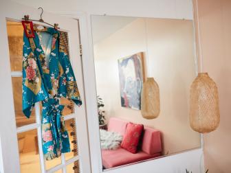 Floral Robe Hangs on a Door Near a Mirror