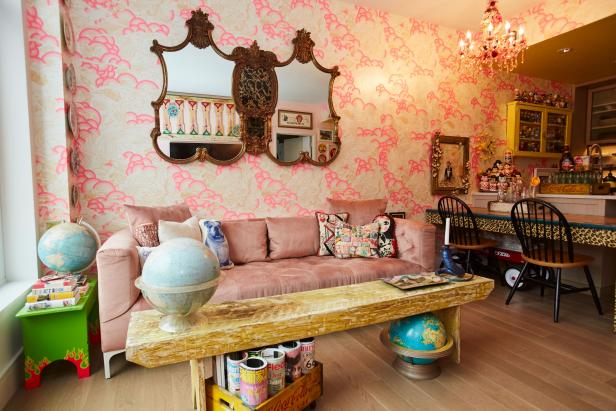 A Pink Velvet Sofa Sits Against a Wallpapered Wall in a Living Room | HGTV