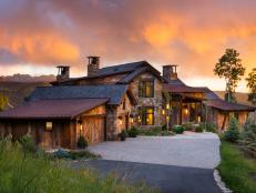Sun Sets Behind Stone Mansion in Mountains