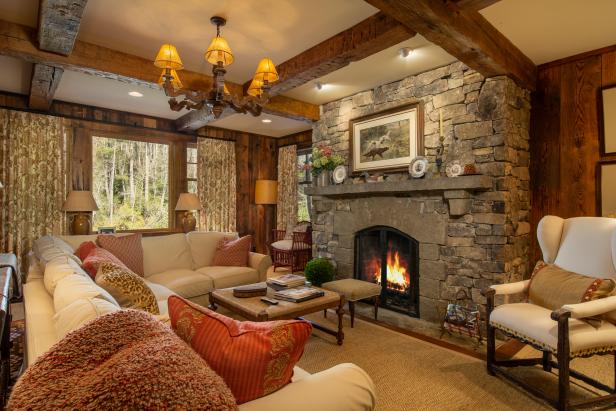 Cozy, Rustic Family Room with Stone Fireplace and Wood Beam Ceiling | HGTV