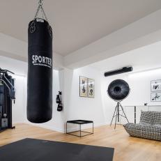 Contemporary Black and White Home Gym with Punching Bag