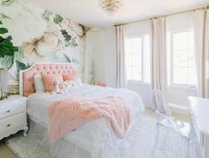 This 9-year-olds bedroom, designed by Little Crown Interiors, is a dreamy feminine space that features a cozy reading nook. This stylish space has a floral accent wall and touches of pink, creating a sweet bedroom designed to grow with the child.