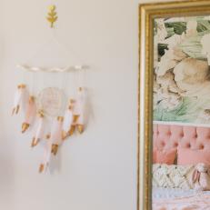 Girl's Pink & White Bedroom Features a Gold Framed Mirror