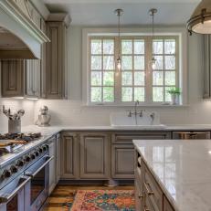 Country Kitchen With White Tile Walls and Marble Countertops