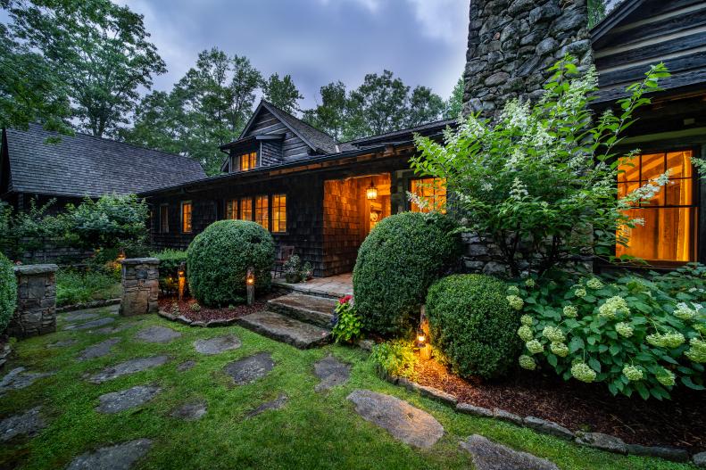Log Cabin Mansion Next to Garden With Flagstone Pathway
