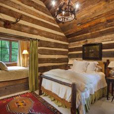 Log Cabin Bedroom With Daybed and Antler Decoration