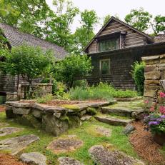 Stone Wall and Raised Stone Bed in Garden Outside Log Cabin