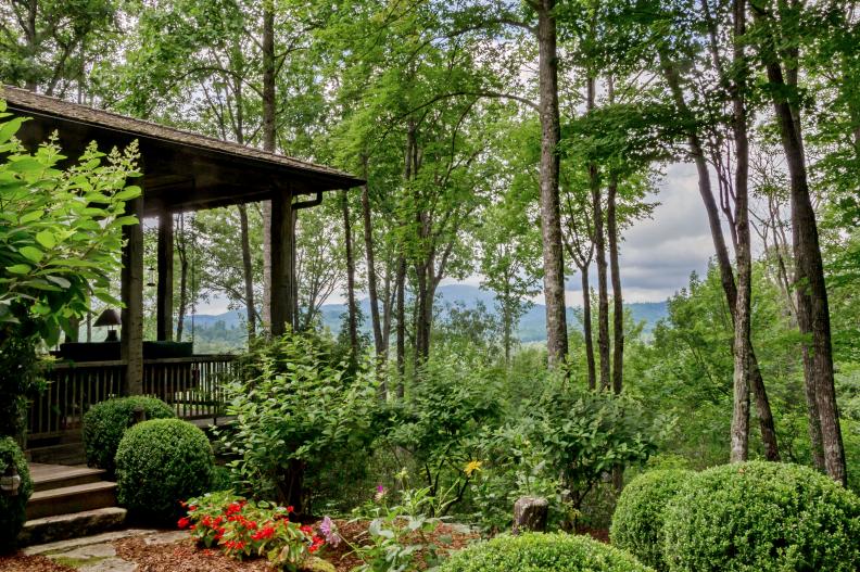 Covered Porch Next to Flower Garden Has Mountain View