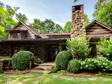 Log Cabin Mansion Front Entry With Landscaping and Stone Chimney